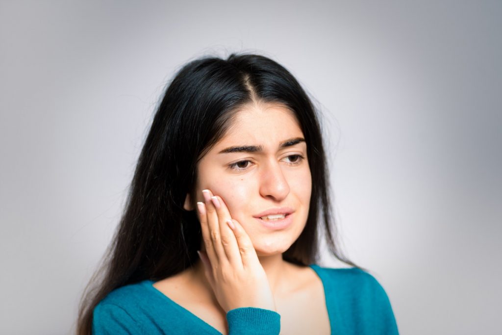 Woman suffering from gum inflammation