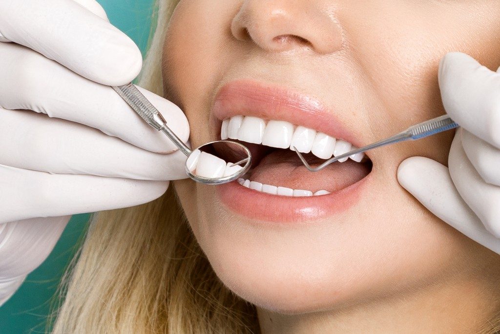 dentist cleaning pearly white teeth