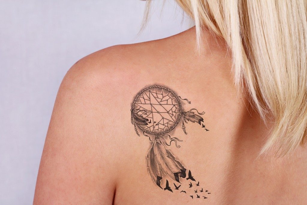 Dream catcher tattoo on a woman's back