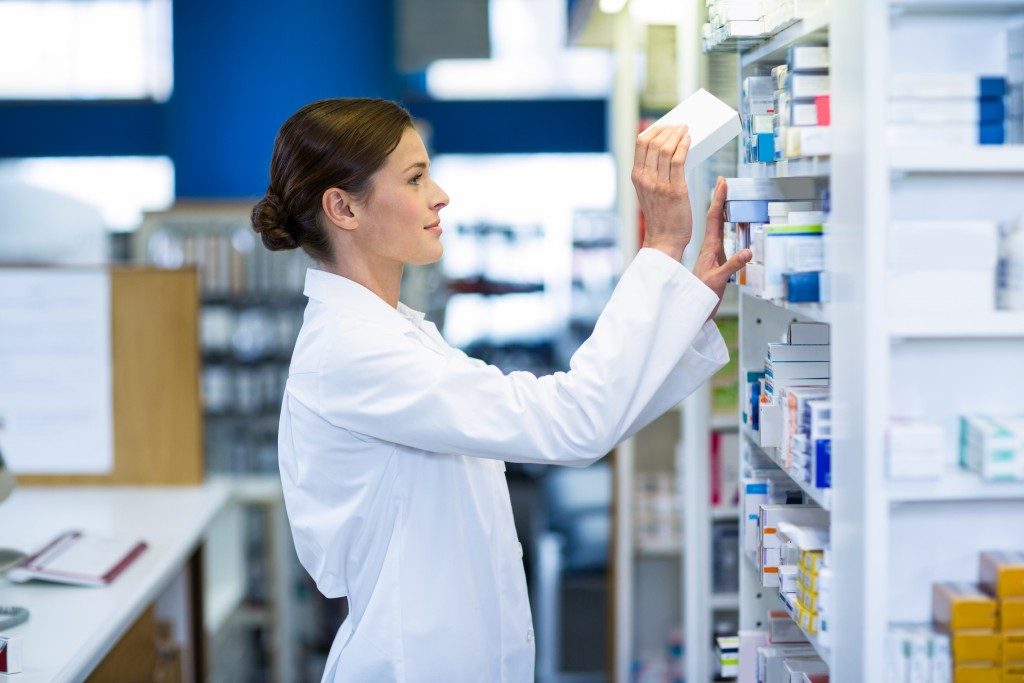 Female pharmacist looking for medicine
