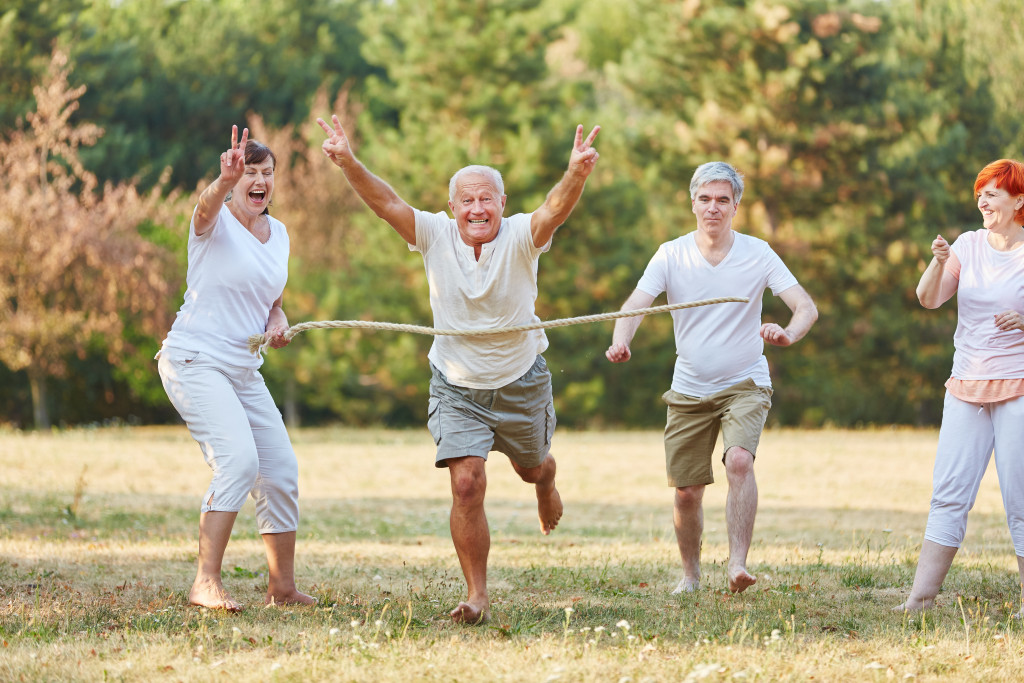 senior citizens happily running through a field