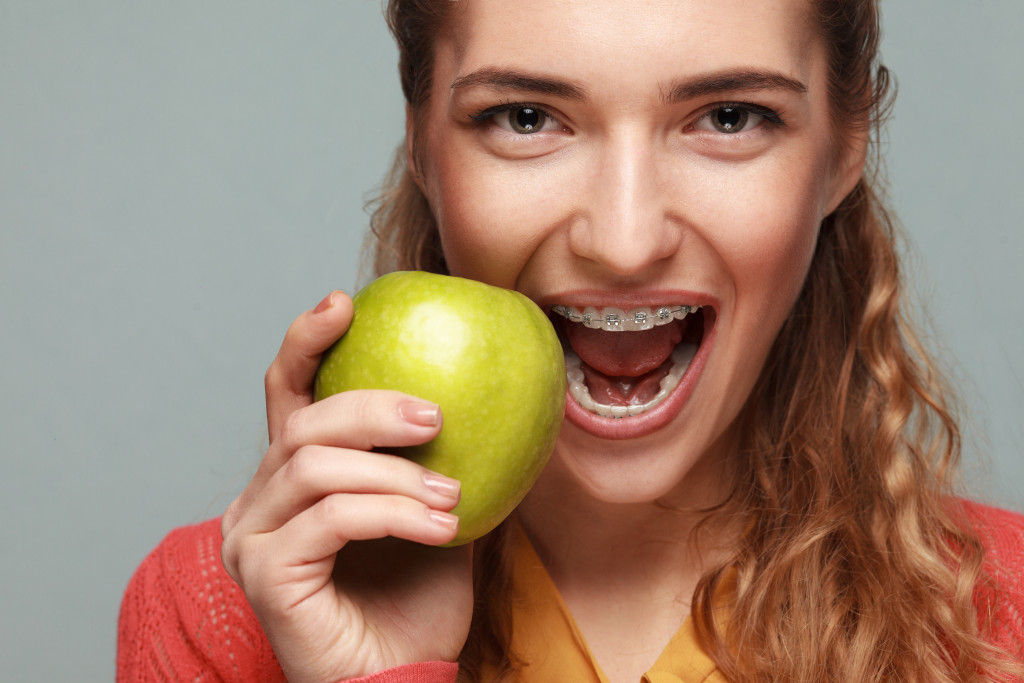 woman about to bite an apple