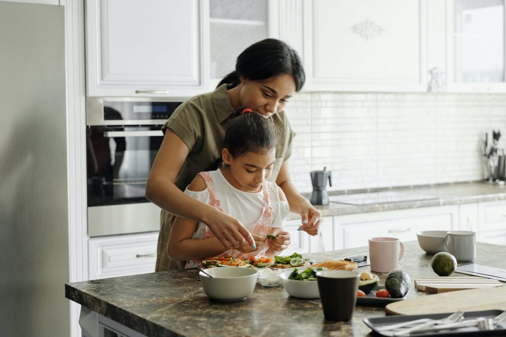 mother and daughter preparing food