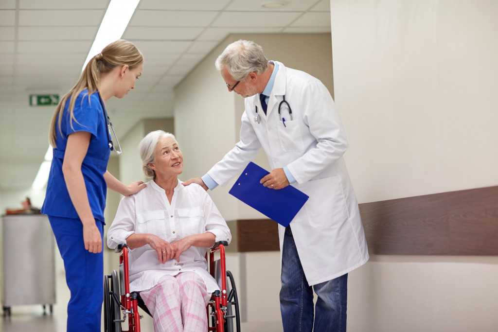 Gerontologist and elderly patient with nurse