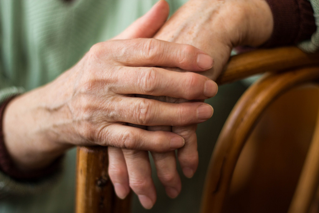An old man with hand arthritis