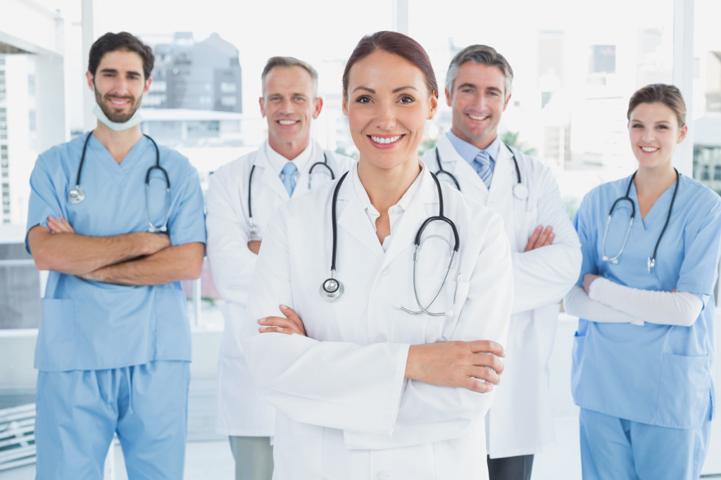 medical professional together smiling and with their arms wrapped in their chests