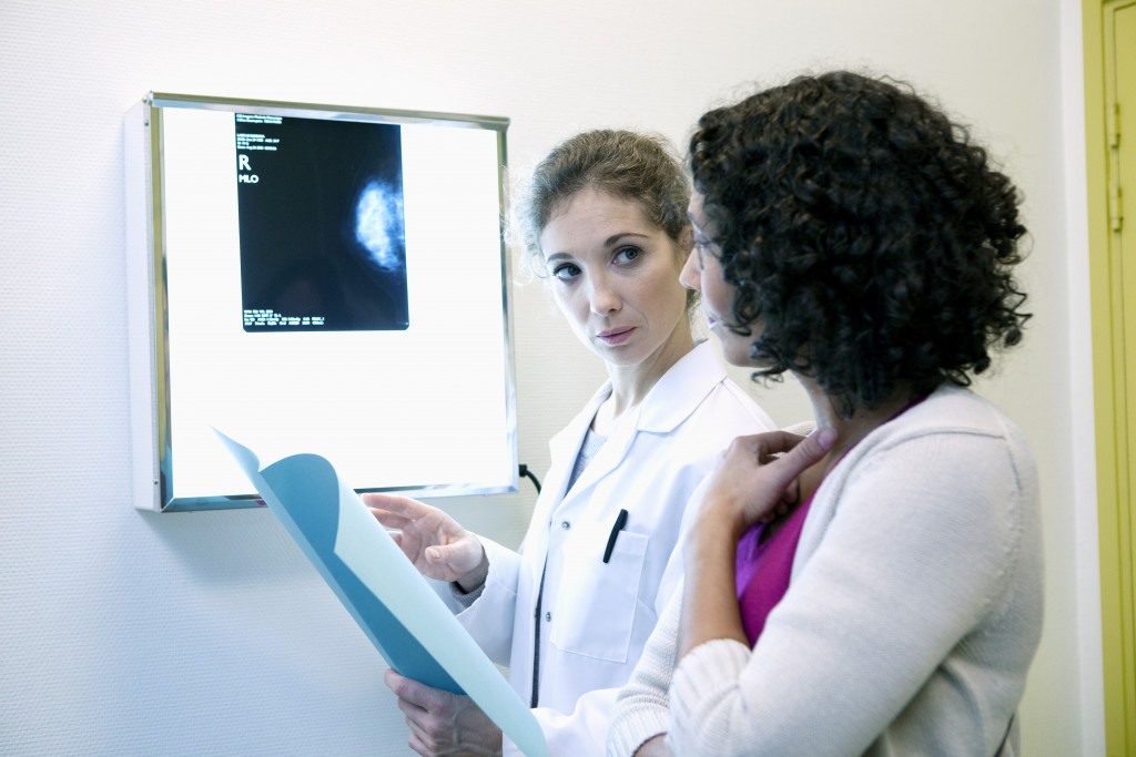 A doctor showing patient the result of her mammogram