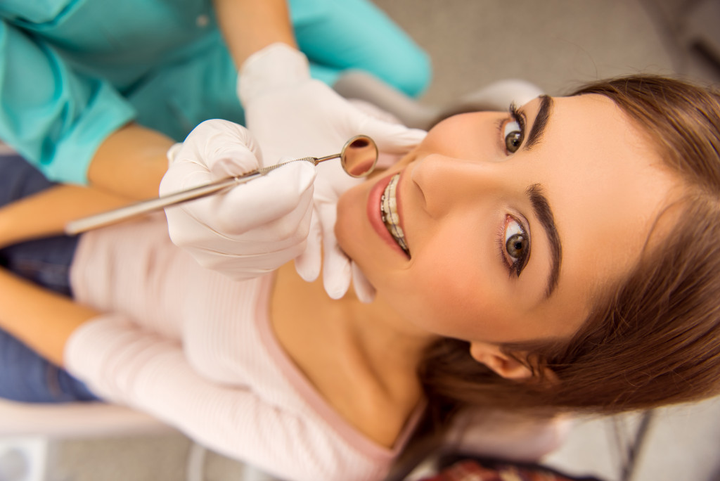a young woman in a dental chair getting teeth checked