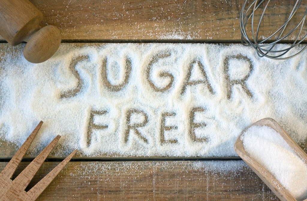 word sugar free carved in a sugar background with baking tools around