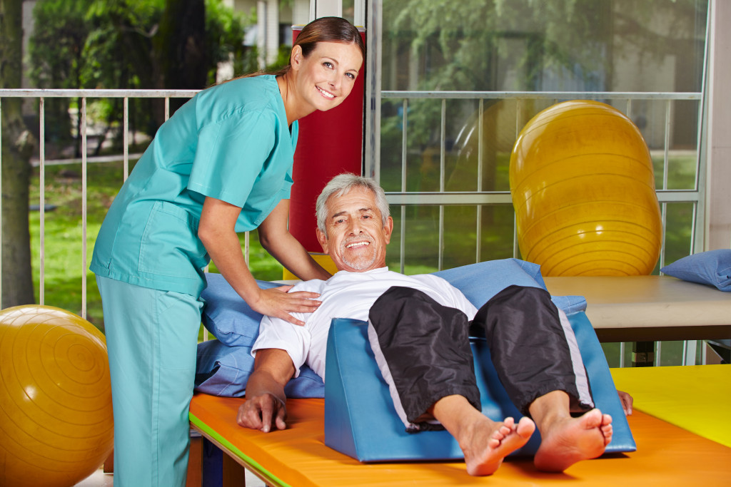 senior man cared assisted by a nurse