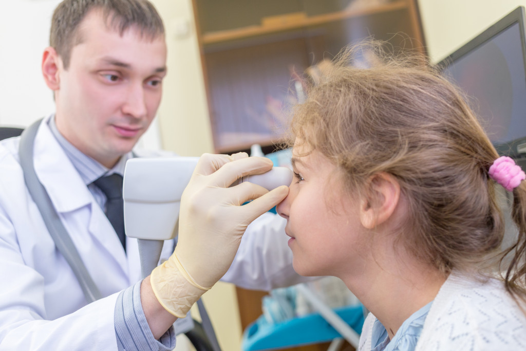 An ophthalmologist examining a girl's eyes