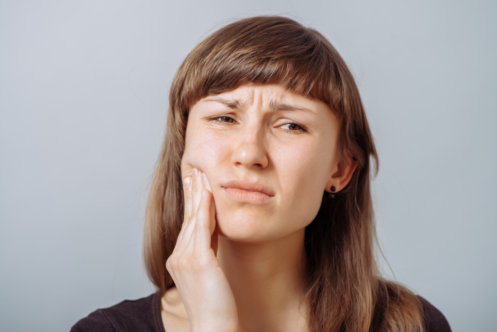 woman with toothache concept of gum disease