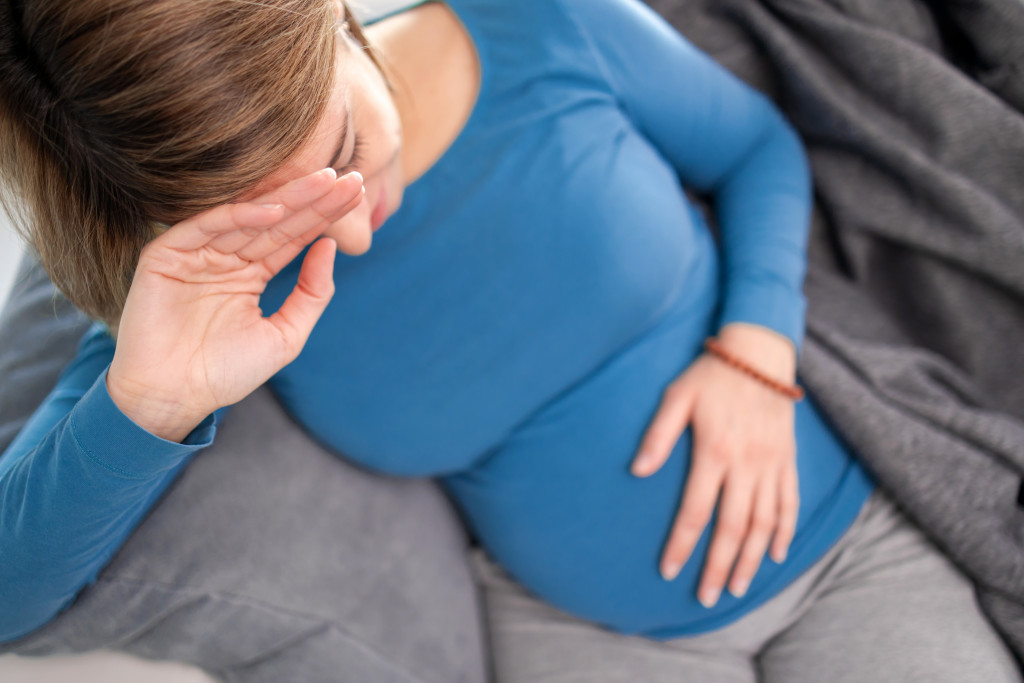 Depressed pregnant woman at home