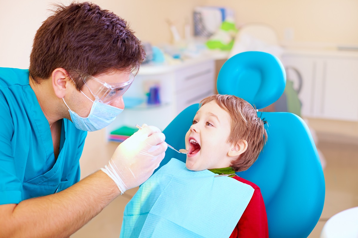 A boy getting a dental exam at the clinic