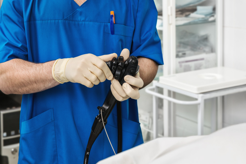 male doctor handling an endoscopy device