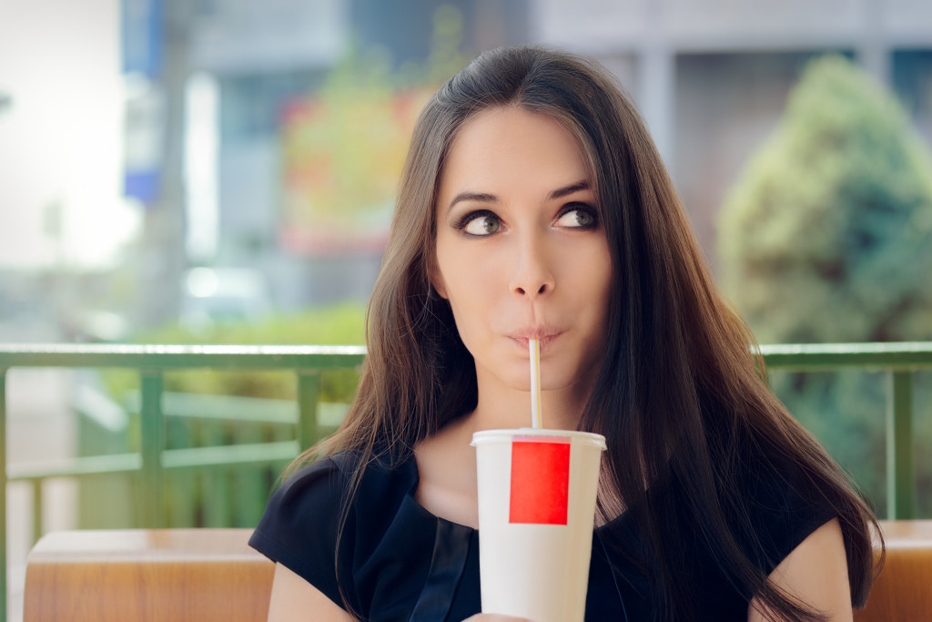 a woman drinkng soda